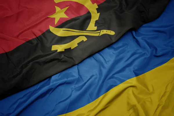 Ukrayna 'nın renkli bayrağı ve Angola' nın ulusal bayrağı sallanıyor.. — Stok fotoğraf