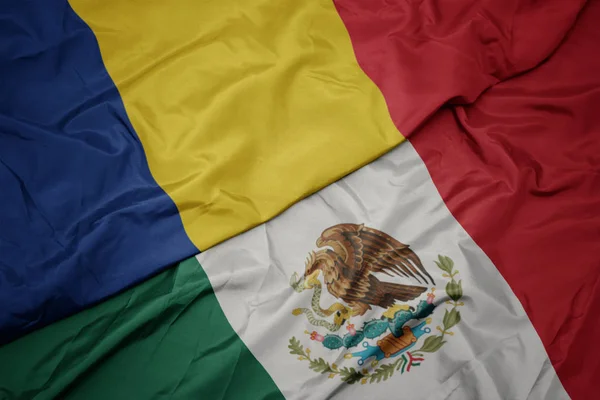 Waving colorful flag of mexico and national flag of romania. macro — Stock Photo, Image