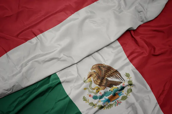 Waving colorful flag of mexico and national flag of indonesia. macro — Stock Photo, Image
