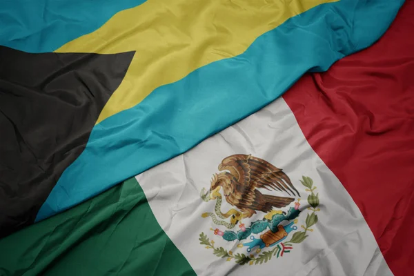 Machanie kolorową flagą Meksyku i flagą narodową Bahamów. makro — Zdjęcie stockowe