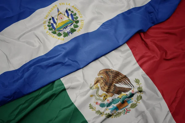 Waving colorful flag of mexico and national flag of el salvador. macro — Stock Photo, Image