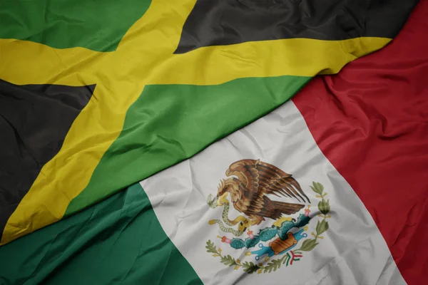 Waving colorful flag of mexico and national flag of jamaica. macro — Stock Photo, Image