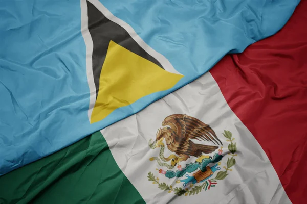 Waving colorful flag of mexico and national flag of saint lucia. macro — Stock Photo, Image