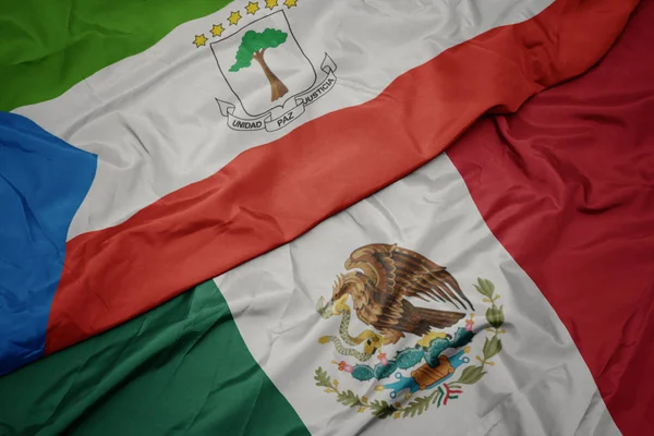 Viftande färgglada flagga mexikanska och nationella flagga equatorial guinea. makro — Stockfoto