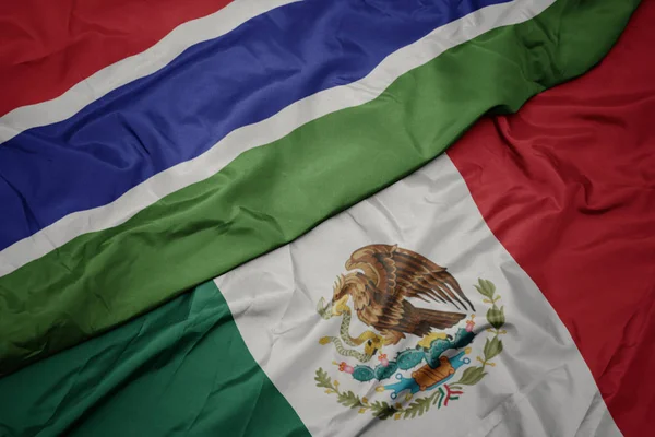 Waving colorful flag of mexico and national flag of gambia. macro — Stock Photo, Image