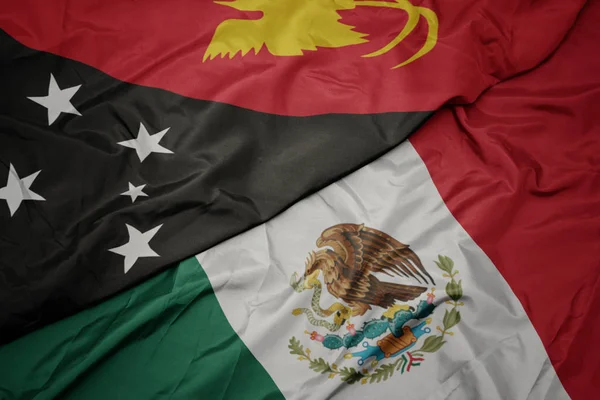 Waving colorful flag of mexico and national flag of Papua New Guinea . macro — Zdjęcie stockowe