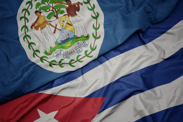 Schwenken bunte Fahne Kubas und Nationalflagge Belize. — Stockfoto