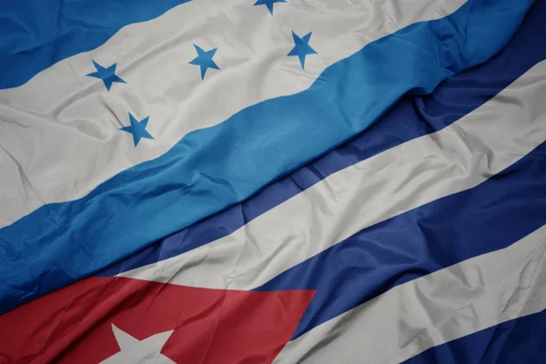 Waving colorful flag of cuba and national flag of honduras. — Stock Photo, Image