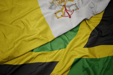 Jamaika 'nın renkli bayrağı ve Vatikan' ın ulusal bayrağı sallanıyor..