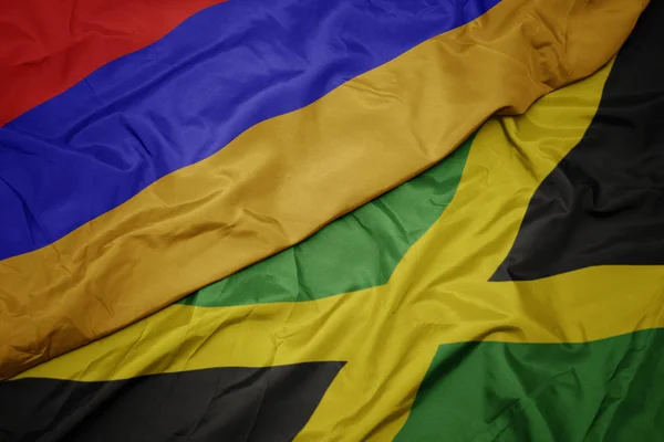 Ondeando colorida bandera de jamaica y bandera nacional de armenia . — Foto de Stock