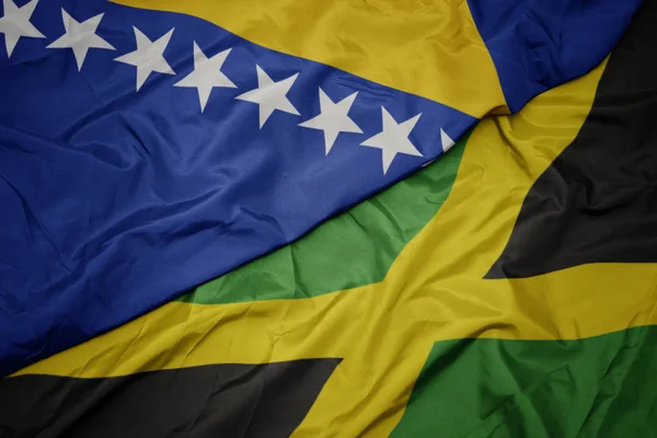 Ondeando colorida bandera de jamaica y bandera nacional de bosnia y Herzegovina . — Foto de Stock