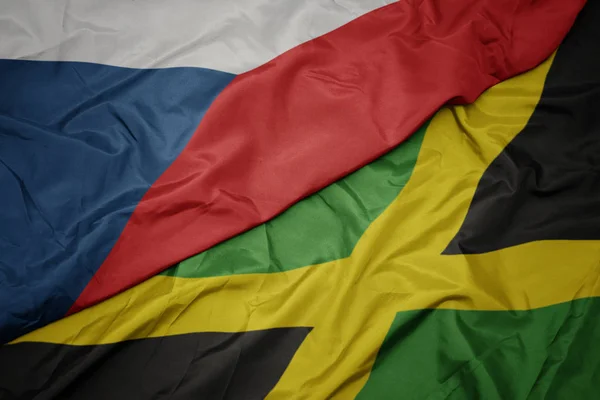 Vlající barevnou vlajkou Jamajky a národní vlajkou České republiky. — Stock fotografie