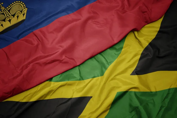 Ondeando colorida bandera de jamaica y bandera nacional de liechtenstein . —  Fotos de Stock