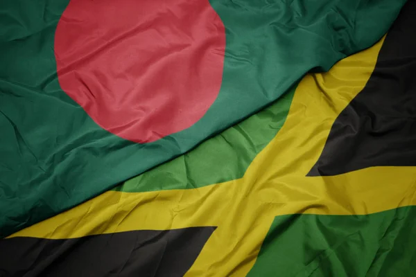 Ondeando colorida bandera de jamaica y bandera nacional de bangladesh . —  Fotos de Stock