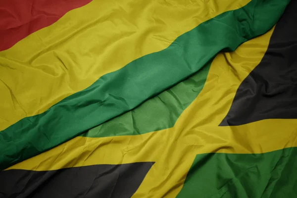 Waving colorful flag of jamaica and national flag of bolivia. — Stock Photo, Image