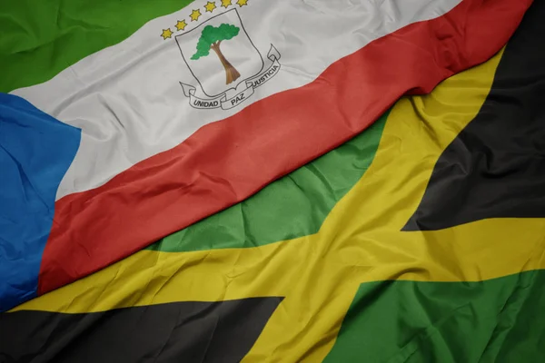 Ondeando colorida bandera de jamaica y bandera nacional de guinea ecuatorial . —  Fotos de Stock