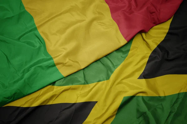 Waving colorful flag of jamaica and national flag of mali. — Stock Photo, Image