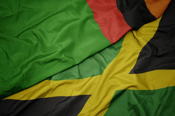 Waving colorful flag of jamaica and national flag of zambia. — Stock Photo, Image