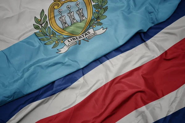 Waving colorful flag of costa rica and national flag of san marino. — Stock Fotó