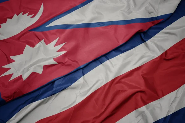 Waving colorful flag of costa rica and national flag of nepal. — Stock Photo, Image
