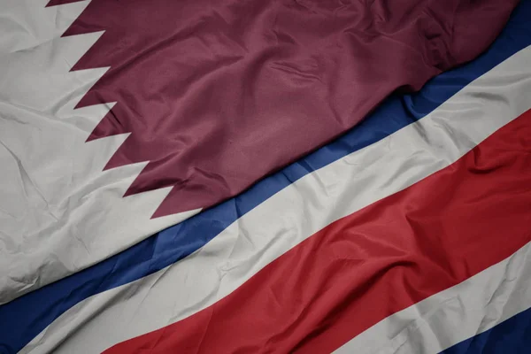 Waving colorful flag of costa rica and national flag of qatar. — Stock Photo, Image