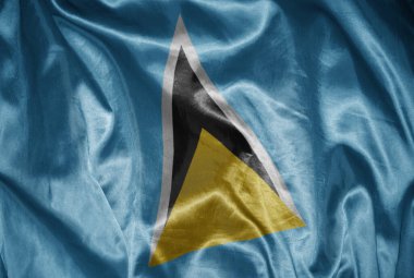 Azize Lucia 'nın renkli, büyük ulusal bayrağını ipeksi bir dokuda sallıyordu.