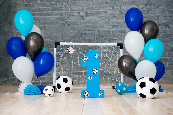 Decor of the first year of football, gates, balls and soccer balls.