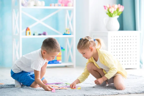 Мальчик с девочкой играют дома — стоковое фото