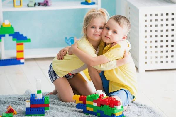 Boy with a girl playing at home — Stock Photo, Image
