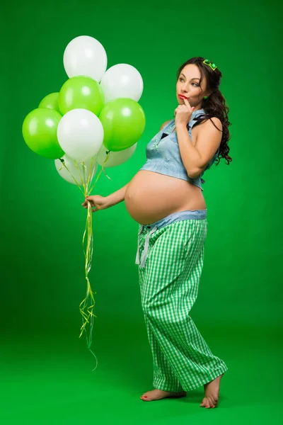 Donna Incinta Con Palloncini Sfondo Verde Guarda Pancia Previsione — Foto Stock