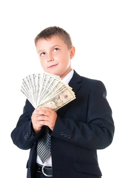 Молодий хлопчик-початківець школяр у діловому костюмі тримає гроші в руках. Як заробити перший мільйон доларів — стокове фото