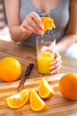 pişirme, gıda ve veganism kavramı, Vigor ve sağlıklı yeme-kadın el sıkmak taze portakal suyu yakın