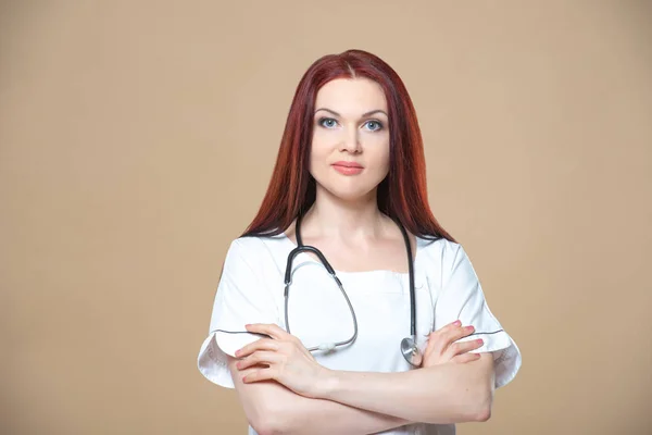 Female profession. Good family, children's, woman pediatrician or nurse with a stethoscope isolated on a blue background. Concept medical consultation