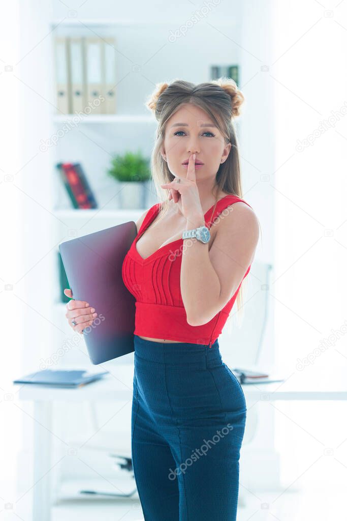 The girl in the office holds folders in her hands. Remote work online, female business.