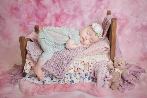 Little Newborn Baby Girl Turquoise Suit Sleeps Wooden Crib Pink — Stock Photo, Image