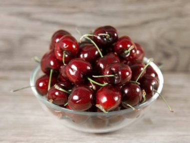 Tahta arka planda olgun kirazlar.