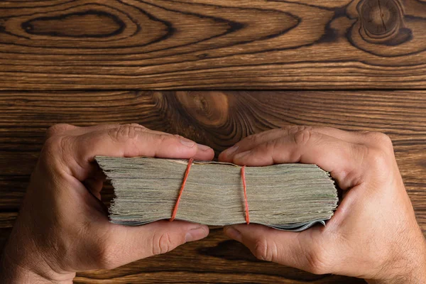 Male Hands Holding Thick Wad Money Tied Rubber Bands Rustic — Stock Photo, Image