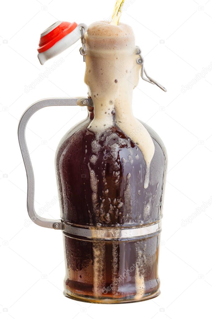 Fresh foam spilling down an over filled German growler jug from the frothy head on craft or draft beer isolated on white