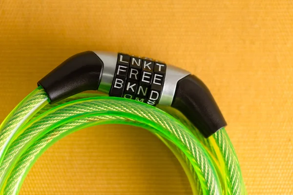 Coiled steel bike lock in green plastic with a combination lock using the code - Free - for protection