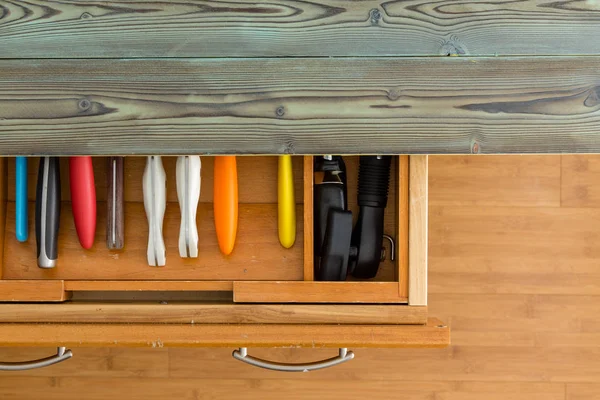 Partially Opened Knife Drawer Showing Colorful Handles Wooden Cabinet Rustic — Stock Photo, Image