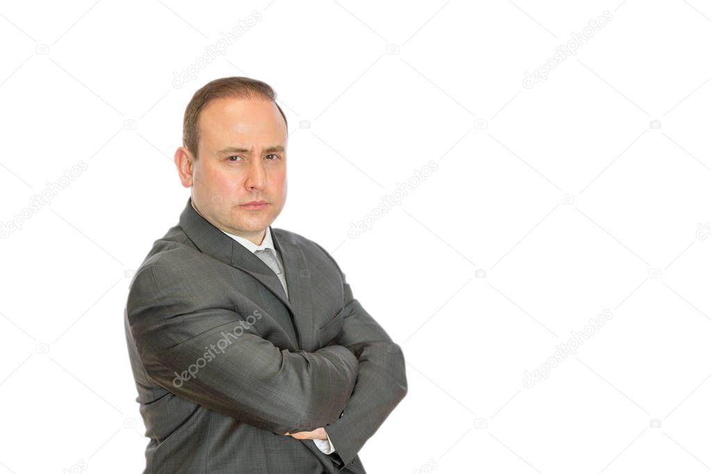 Stern businessman with crossed arms and copy space