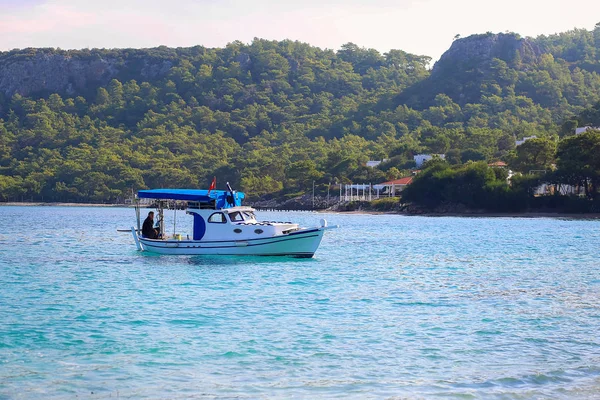 The boat floats across the Mediterranean Sea. The fishing boat with the Turkish flag. Walk by the boat by sea