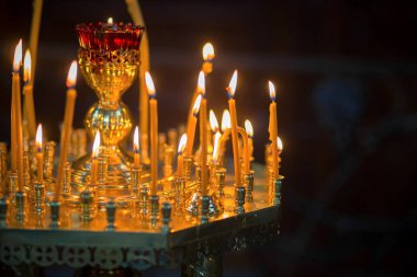 The burning candles for a prayer in Orthodox church