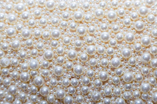 Pearl continuous background. Texture from beads of white pearls