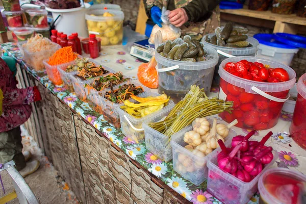 Counter with fermented vegetables in the market. Sale of salads from the salted vegetables