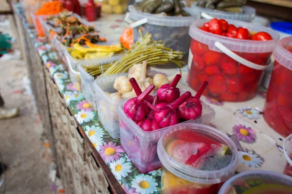 Counter with fermented vegetables in the market. Sale of salads from the salted vegetables