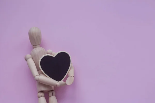 Wooden Puppet Man Pink Background Holding Black Chalkboard Heart — Stock Photo, Image