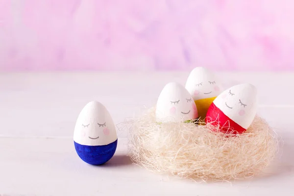 a group of funny colorful eggs - a concept of merry Easter, funny characters, emotions. One against al