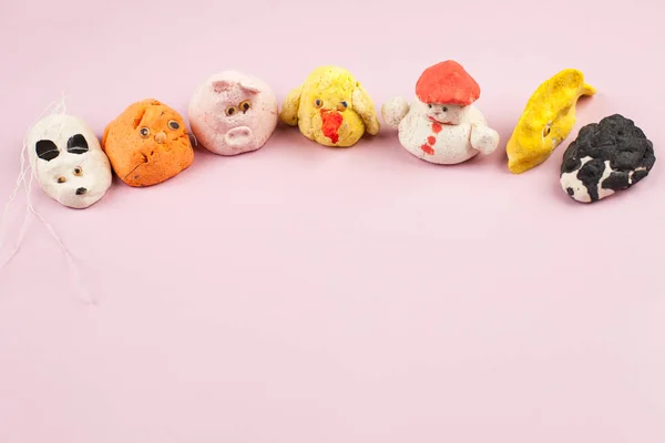 Children's crafts from salted dough - different animals, heart, flowers painted with colors, copy space