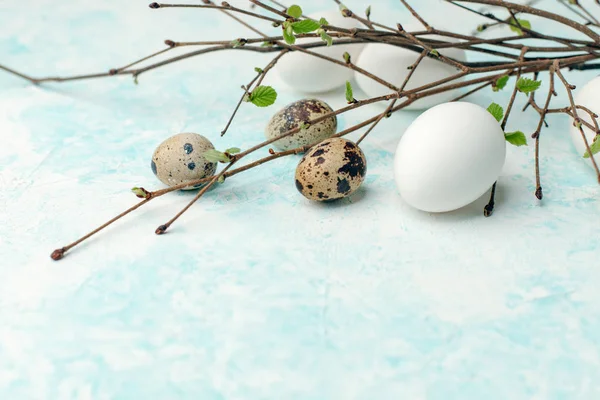Springtime holiday seasonal background - eggs and fresh greenery